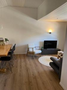 a living room with a couch and a table at Ferienwohnung Monya in Sörenberg