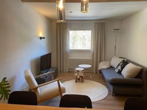 a living room with a couch and a table at Ferienwohnung Monya in Sörenberg