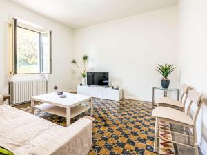 a living room with a couch and a table at Holiday Home Guest House Viotti by Interhome in Castel Rocchero +26 photos