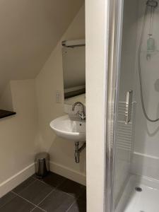 een badkamer met een wastafel en een douche bij Moat House 6 in Fort Augustus
