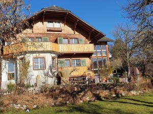 a woman standing in front of a large house at Garden Oasis In Bern in Liebefeld