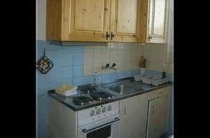 a kitchen with a stove and a sink at Cad Maté 2 in Maloja