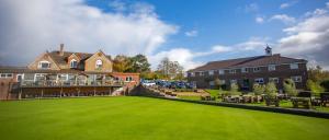 a large green lawn in front of a building at Bells Hotel in Coleford