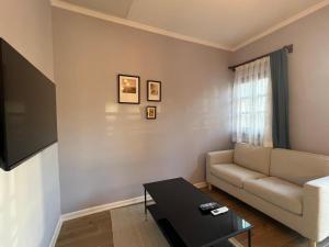 a living room with a couch and a table at Hotel Mille Kaleiçi in Antalya