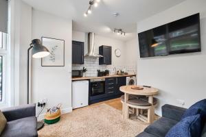 a kitchen and living room with a couch and a table at Kendal Lane Apartments in Central Station +29 photos