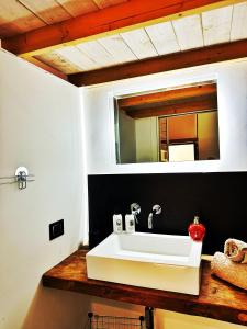 a bathroom with a white sink and a mirror at Casa Terranova in Pozzallo