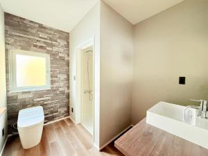 a bathroom with a toilet and a sink at The Lobs 5, Rusutsu in Kimobetsu