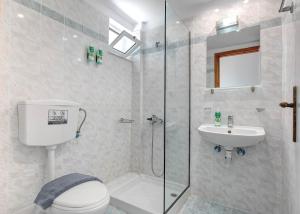 a bathroom with a shower and a toilet and a sink at Armonia Hotel by Zante Plaza in Laganas +45 photos