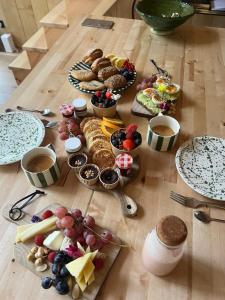 a table with a bunch of different types of food at Ecolodge de la Palombiere in Saint-Clar +31 photos