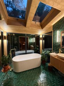 a large bathroom with a large tub and a sink at Ecolodge de la Palombiere in Saint-Clar