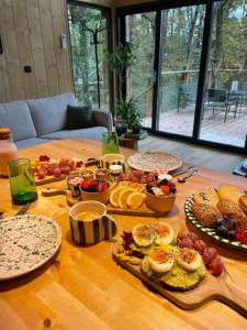 a wooden table with a bunch of food on it at Ecolodge de la Palombiere in Saint-Clar
