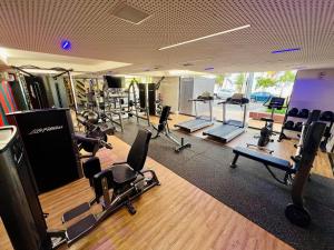 a gym with several treadmills and chairs in it at Unity - Flat Premium à Beira-Mar em Cabo Branco in João Pessoa