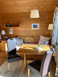 a dining room with a wooden table and chairs at Haus Werner, Ferienwohnung mit Sommercard in Ramsau am Dachstein