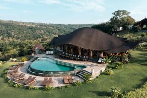an overhead view of a house with a swimming pool at Ketanu Bamboo Lodge Sumba in Praikalogu