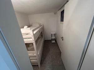 a small room with a bunk bed and a door at Gemütliche Souterrainwohnung mit gratis Parkplatz in St. Gallen +9 photos
