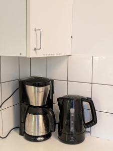 a coffeemaker and a coffee maker on a kitchen counter at Grand Hostel Ivalo in Ivalo
