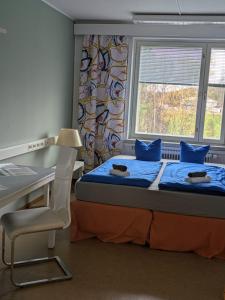 a bedroom with two beds and a desk and a window at Grand Hostel Ivalo in Ivalo +86 photos