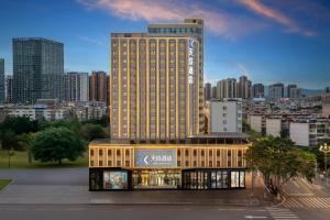 a building in front of a city skyline at Tiancheng Hotel Liangjiahe Metro Station Branch in Kunming