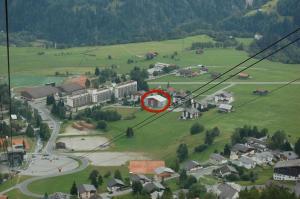 a red circle is sitting on top of a green field at Casa Caglina in Disentis