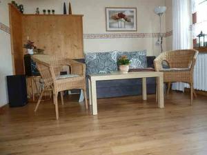 a living room with a couch and chairs and a table at Ferienwohnung Lotti in Brotterode-Trusetal