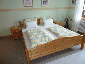 a large wooden bed in a bedroom at Ferienwohnung Lotti in Brotterode-Trusetal