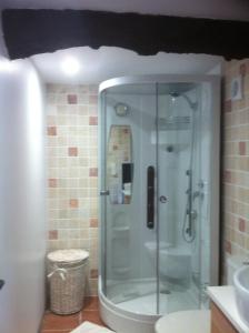 a bathroom with a shower with a glass door at Le Champ des Possibles in Manerbe