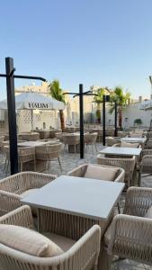 a row of tables and chairs in a patio at Azard Hotel in Al Madinah