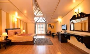 a bedroom with a bed and a sink and a mirror at Belvedere Palace Nainital in Nainital