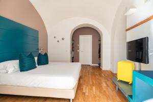 Postel nebo postele na pokoji v ubytování Hotel Piazza Bellini & Apartments