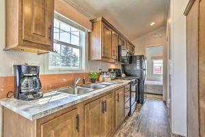 a kitchen with a sink and a refrigerator at Gather, Celebrate, Unwind at Equestrian House PA in Pleasant Mount