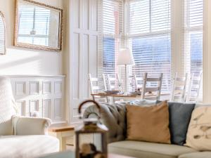 a living room with a couch and a table and chairs at Apartment 1 - Uk32244 in Aberdyfi