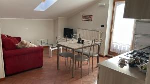 a kitchen and living room with a table and chairs at Eden Apartment di Manenti Andrea in Oltre il Colle