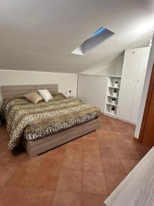 a bedroom with a bed with a cheetah blanket at Eden Apartment di Manenti Andrea in Oltre il Colle