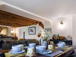 a dining room with a table with dishes on it at Rivendell Cottage in Liskeard