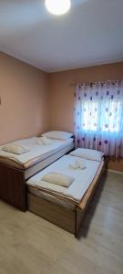 two beds sitting next to each other in a room at Apartman Nedo Međugorje in Međugorje