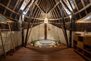 an inside view of a yurt with a table in the middle at Ketanu Bamboo Lodge Sumba in Praikalogu +59 photos