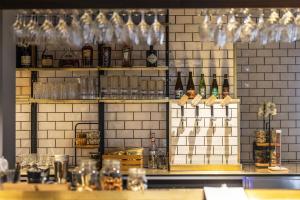 a bar with a bunch of bottles and glasses at Scandic The Mayor in Aarhus +43 photos