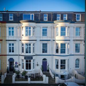 a white building with a purple door at The Helaina in Scarborough