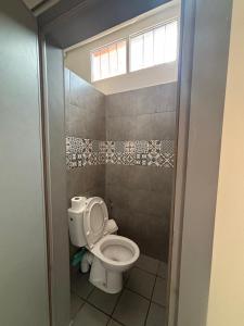a bathroom with a toilet and a window in it at Sunrise Camp in Mirleft