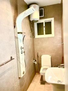 a small bathroom with a toilet and a sink at شقة 9 in Al-Safa