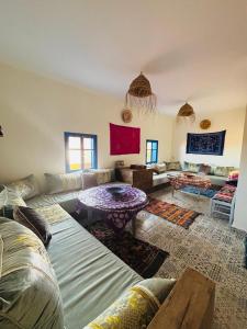 a living room with a couch and a table at Sunrise Camp in Mirleft