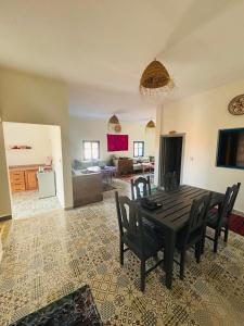 a dining table and chairs in a living room at Sunrise Camp in Mirleft
