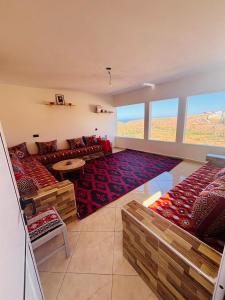 a living room with a couch and a table at Sunrise Camp in Mirleft
