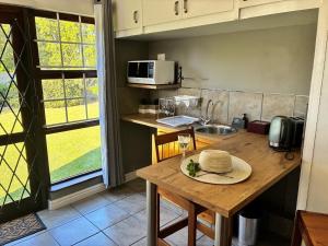 a kitchen with a table with a hat on it at Little Oasis - Palm Room in Port Elizabeth