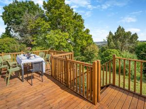 a wooden deck with a table and chairs on it at Halfstone House in Llanelli