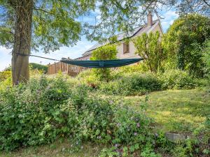 a hammock in a garden in front of a house at Halfstone House in Llanelli