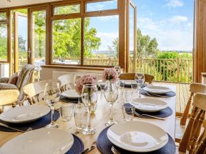 a table with glasses and plates on top of it at Halfstone House in Llanelli