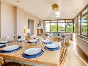 a dining room with a wooden table and chairs at Halfstone House in Llanelli +25 photos