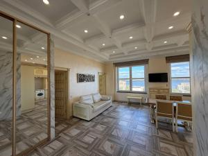 a large living room with a couch and a table at Дельмар Люкс in Dnipro