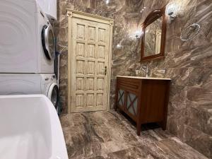 a bathroom with a sink and a washer and dryer at Дельмар Люкс in Dnipro +54 photos